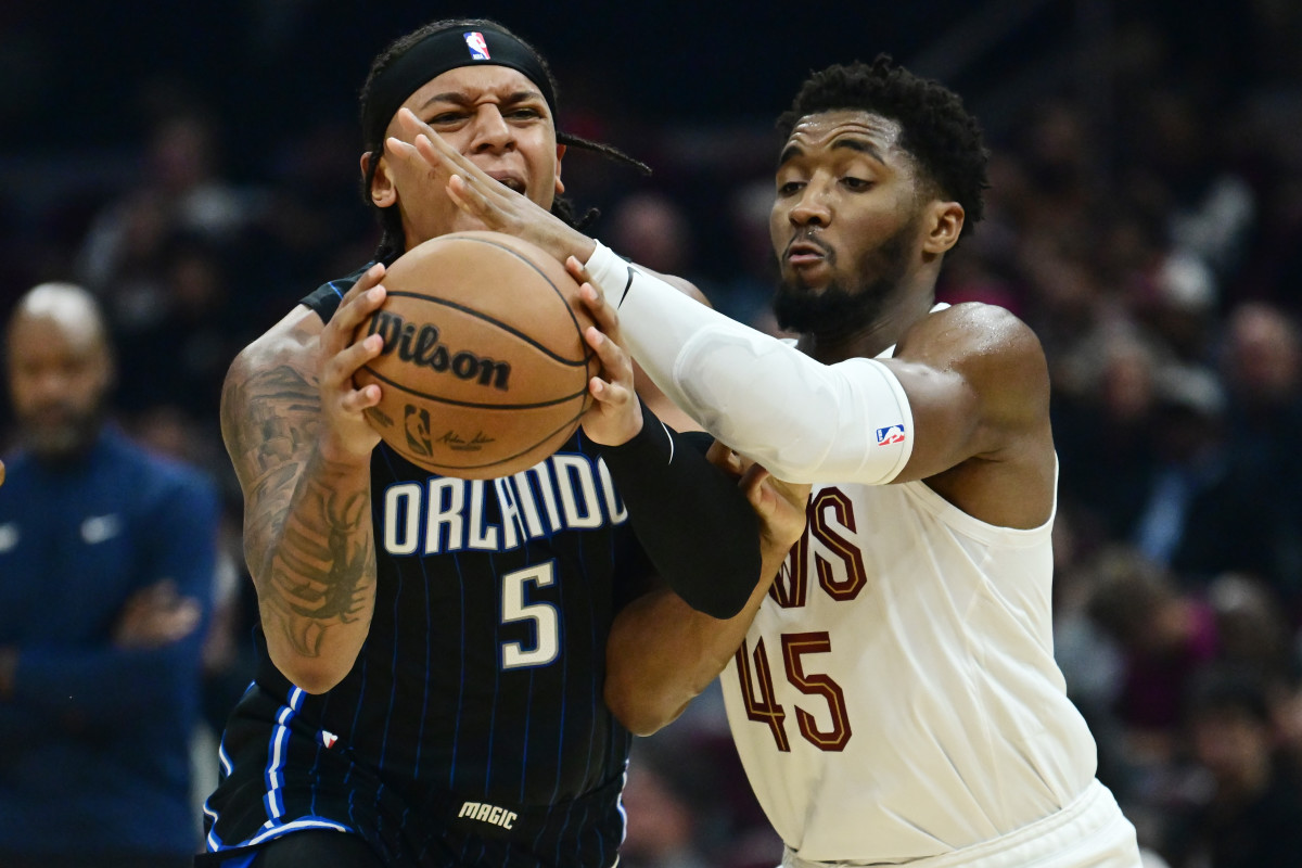 Cleveland Cavaliers guard Donovan Mitchell (45) defends Orlando Magic forward Paolo Banchero (5)